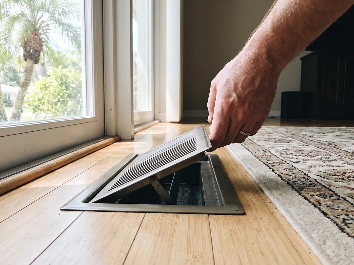 Wentzel's technician inspecting ductwork as part of an AC sizing assessment