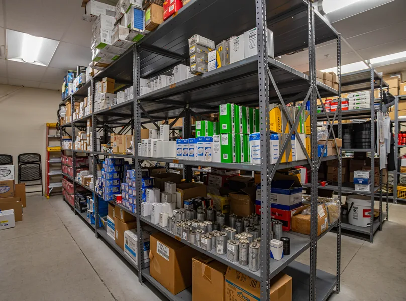 Shelves of in-stock parts and capacitors in the parts room at Wentzel's Sarasota headquarters