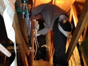 Air Conditioning Technician working in an attic