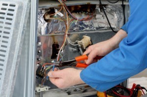 Licensed Electrician Repairing Large Appliance