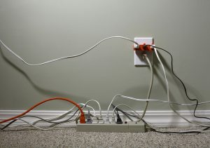 Electrical Wall Outlet Overloaded with Extension Cords