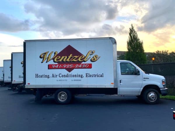 Wentzel's Heating, Air Conditioning, Electrical And Insulation Trucks In Parking Lot